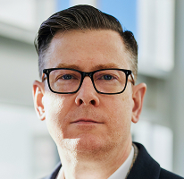 Photographie d'Alexander Hughes, chef de direction d'une plateforme de négoce en cryptomonnaies
